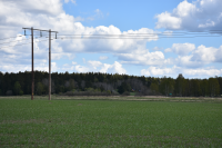 Landskap vid Södertorp i Frösunda. Torpet hörde till Lindholmens gård. Landskapet är ett öppet brukat åkerlandskap.