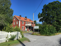 Fastigheten på Skolvägen 9 byggdes 1928 och var tidigare ålderdomshem innan Väsbygården byggdes. Lokalerna användes en period på 1970-talet av Vallentuna kommun som lokaler för byggnadsnämnd och byggnadskontor. Huset har under senare år använts för skolverksamhet och Kulturskola. På skylten står "Hjälmstaskolan, Gymnastik o bad, Parkering".