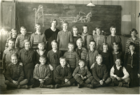 Skolfotografi Hjälmsta skola. Lärarinnan Edit Lindström fotograferas med klass 4 den 7 mars 1933.